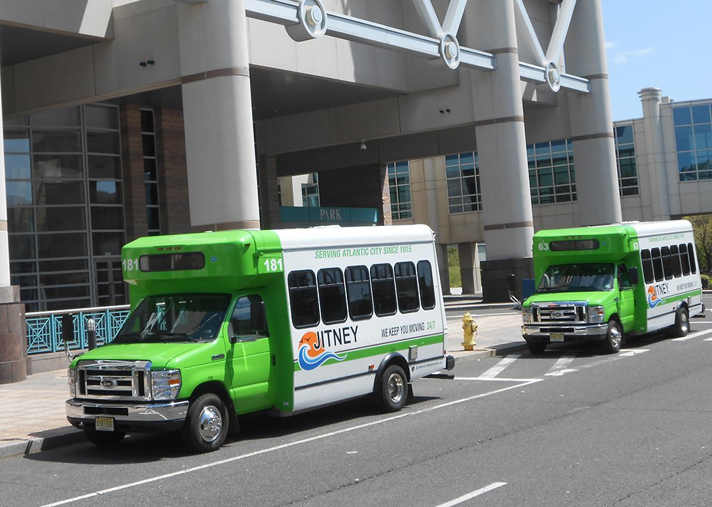 this is a photo of two jitneys parked in front of the ac convention center