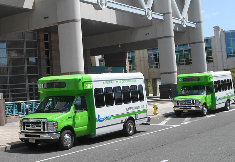 this is a photo of two jitneys parked in front of the ac convention center